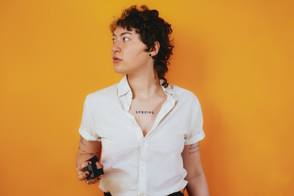 portrait-of-a-nonbinary-autistic-person-in-a-studio-setting-with-a-stim-toy-in-their-hand-7kq3cdg2rji